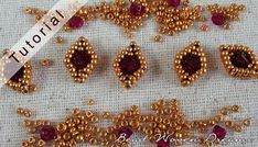 bead moocer designs with gold beads and red stones on a white cloth