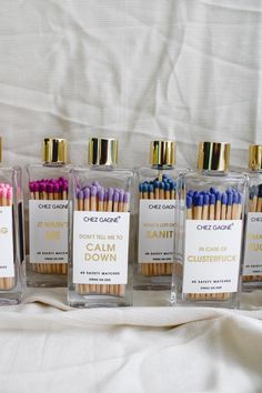 five small bottles with different colored matches inside