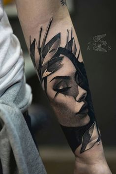 a woman's face with leaves on her arm