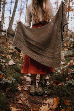 a woman is standing in the woods with a blanket over her head and she has long blonde hair