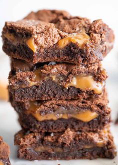 chocolate caramel brownies stacked on top of each other