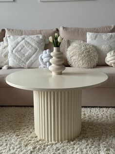 a living room with a couch, table and pillows