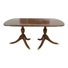 a wooden dining table with two leaves on each end and one leaf at the top