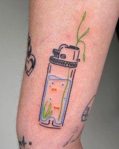 a person with a tattoo on their arm has a jar filled with water and plants