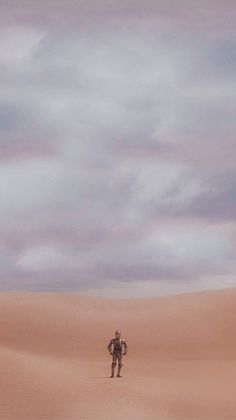 a man standing in the middle of a desert