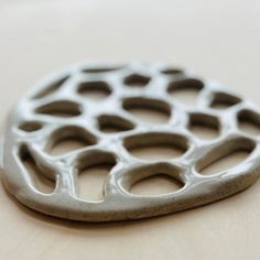 a metal object sitting on top of a wooden table