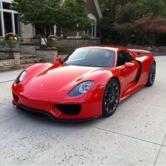 a red sports car parked in front of a house