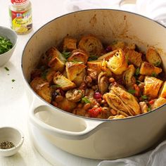 a pot full of food sitting on top of a table