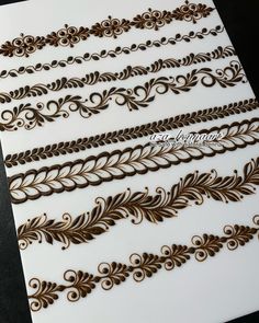 some brown and white designs on a sheet of paper