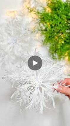 someone is holding an ornament in their hand and it looks like snowflakes