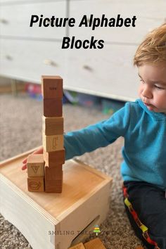 a young child playing with wooden blocks on the floor