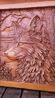 a wooden carving of a wolf in the woods