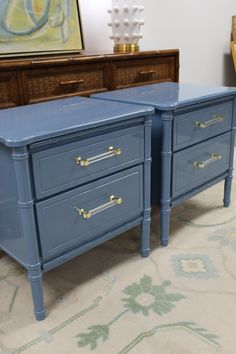 two blue dressers sitting next to each other on top of a carpeted floor