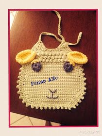 a crocheted bag with an animal's face on it and the words penno ake written in blue