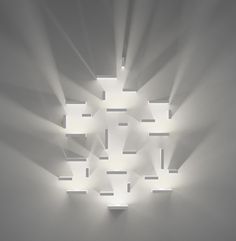 the light is shining through the ceiling in the room with many square lights on it