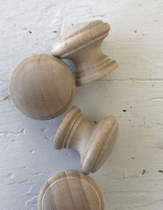 two wooden knobs on the side of a white wall