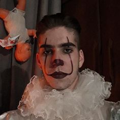 a man with clown makeup on his face