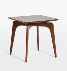 a small wooden table sitting on top of a white floor