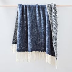 a blue and white blanket hanging on a clothes line