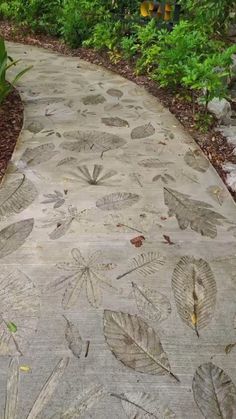 a stone path with leaves painted on it