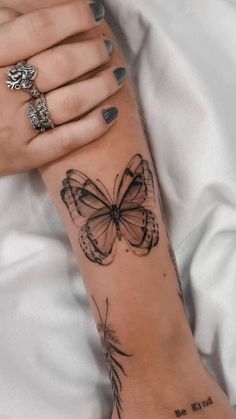 a woman's arm with a butterfly tattoo on it