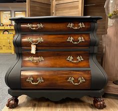 an antique chest of drawers is on display