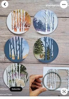 four paper plates with trees on them and one is cut out to look like the forest