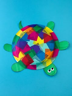 a paper plate with a turtle made out of different colored papers and eyes on it