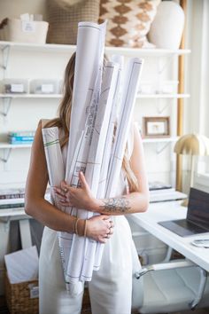 a woman is holding some papers in her hands