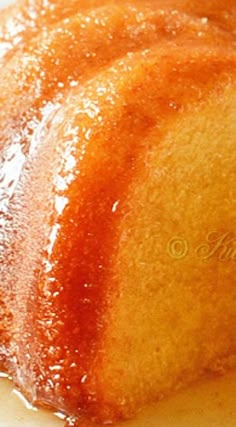 a close up of a bundt cake on a white plate with syrup drizzled over it