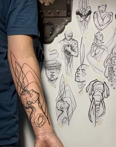 a man's arm with tattoos on it