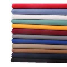 a stack of folded sheets on top of each other in various colors and sizes,