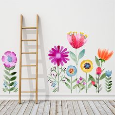 an empty room with flowers painted on the wall and a ladder leaning against the wall