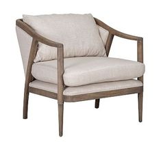 a wooden chair with a white pillow on it's back and armrests