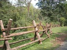 an old wooden fence is next to the road