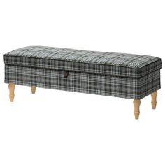 an upholstered bench with wooden legs and plaid fabric on the top, sitting against a white background