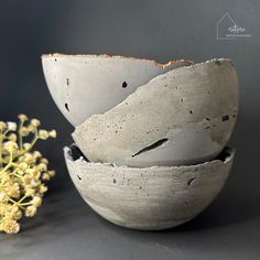 three white bowls sitting next to each other on top of a gray tablecloth covered surface