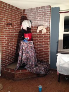 a room with a brick wall and clothes on display