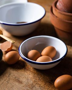 some eggs are in bowls on a table