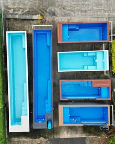 an aerial view of several blue swimming pools