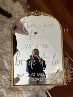 a woman taking a selfie in front of a mirror that says time for tea with the bride to be