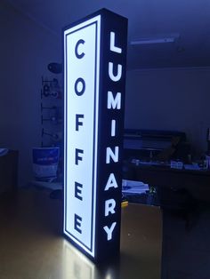 a black and white sign that says columbia on it's side in a dark room