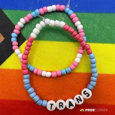 two beaded bracelets with words that spell out the word transs on them