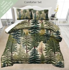 the comforter set is made up with pine trees and evergreens in green tones