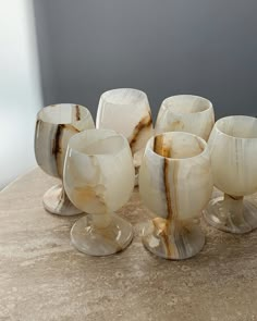 marbled glass cups and saucers sitting on a table