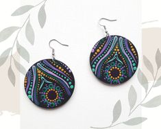 Original hand-painted earrings in this pattern made only once, very light to wear, colorful with a mandala motif, made with the intention of love. Made on a wooden disc (plywood). Diameter is 2 inches (5 cm), weigh 9 grams, painted with acrylic paints, painted dotart, protected by varnish. Stainless steel earwires. The back is black. I can make custom earrings in the colors you dream of with silver or gold-plated earwires (stainless steel). Who created them for you? My name is Karolina Kanimani, I follow the path of conscious development, I am passionate about nature and beauty and I LOVE to create. With joy and passion I create Mandalas from the Heart space, giving each an individual intention. I trained on courses to create Mandalas as a symbol of the Wheel of Life. I invite you to my In Multicolor Hand Painted Jewelry For Festivals, Purple Hand Painted Bohemian Earrings, Bohemian Hand Painted Purple Earrings, Multicolor Peacock Design Earrings As Gift, Multicolor Peacock Design Earrings For Gift, Bohemian Hand Painted Round Jewelry, Hand Painted Multicolor Circular Jewelry, Hand Painted Round Jewelry For Festivals, Mandala Pendant