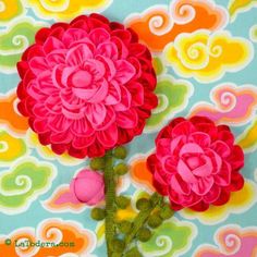 two pink flowers are on a colorful background