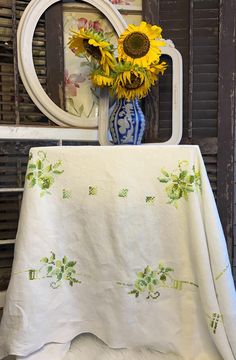 a vase with sunflowers sitting on top of a table