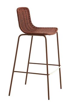 a brown wicker bar stool against a white background with the seat upholstered