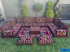 a group of rugs sitting on top of a lush green field